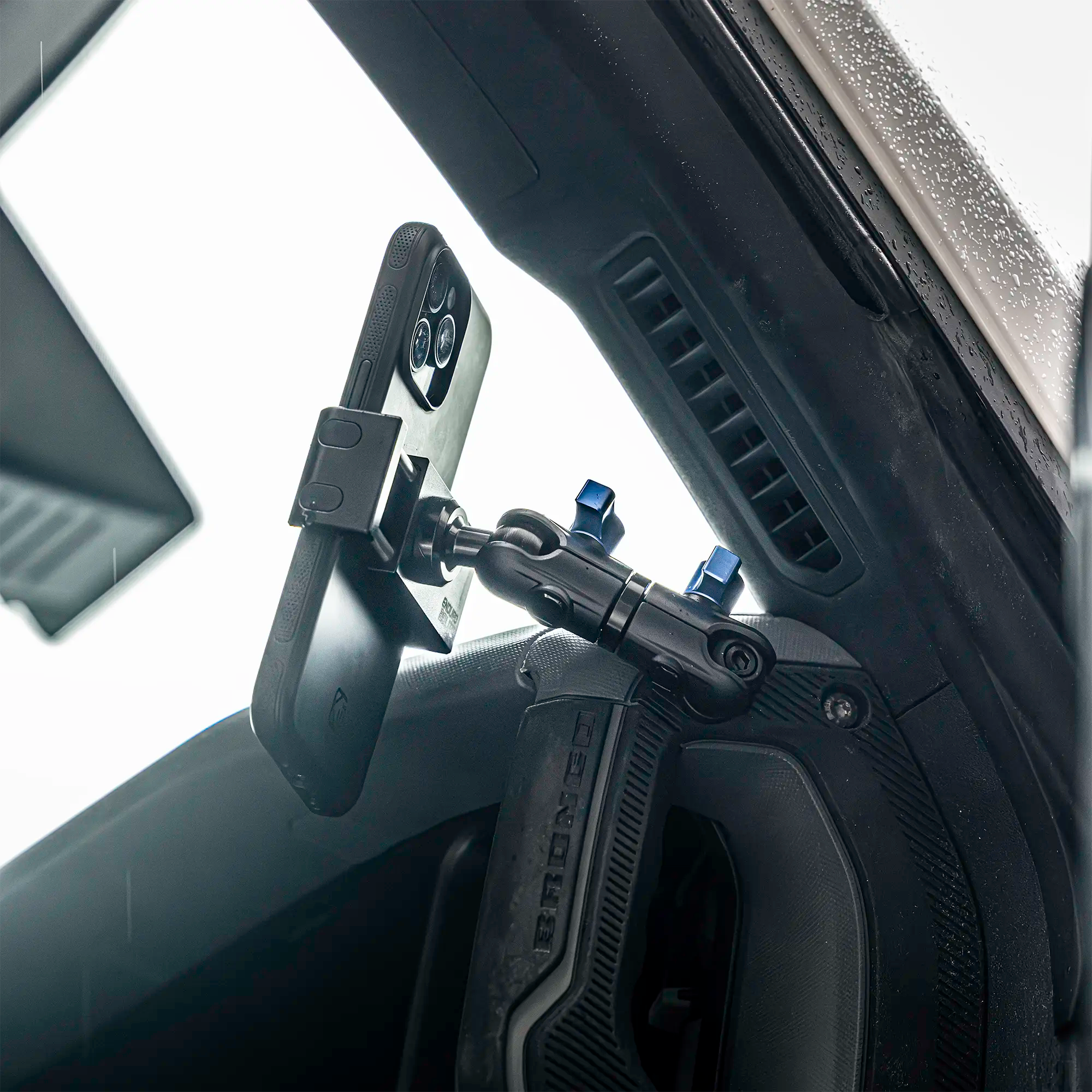 Ford Bronco phone mount with billet spring cradle installed in passenger side grab handle