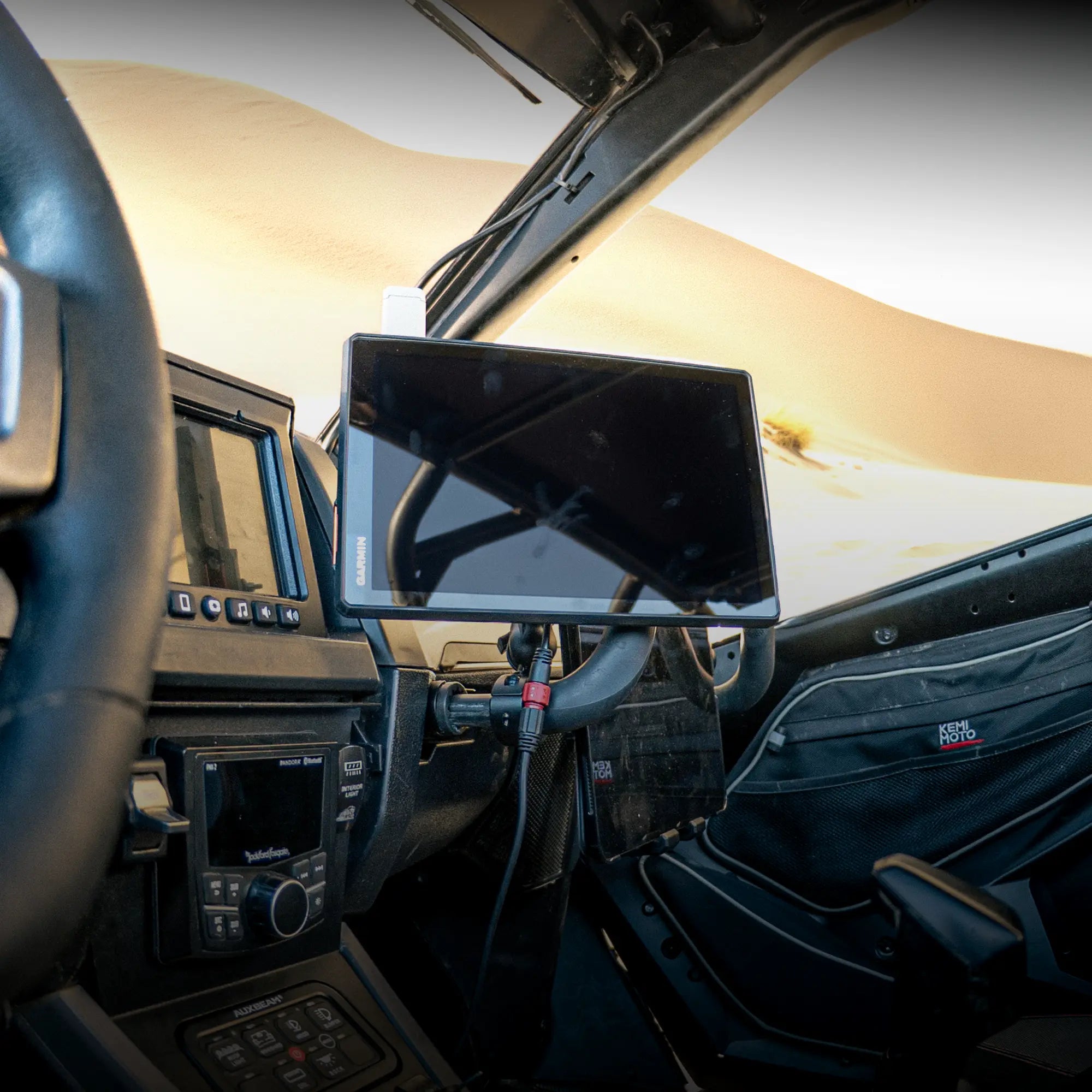Lifestyle photo showing a Polaris RZR Garmin GPS AMPS compatible mount for roll cage and harness bar or u-bar with Garmin GPS device attached