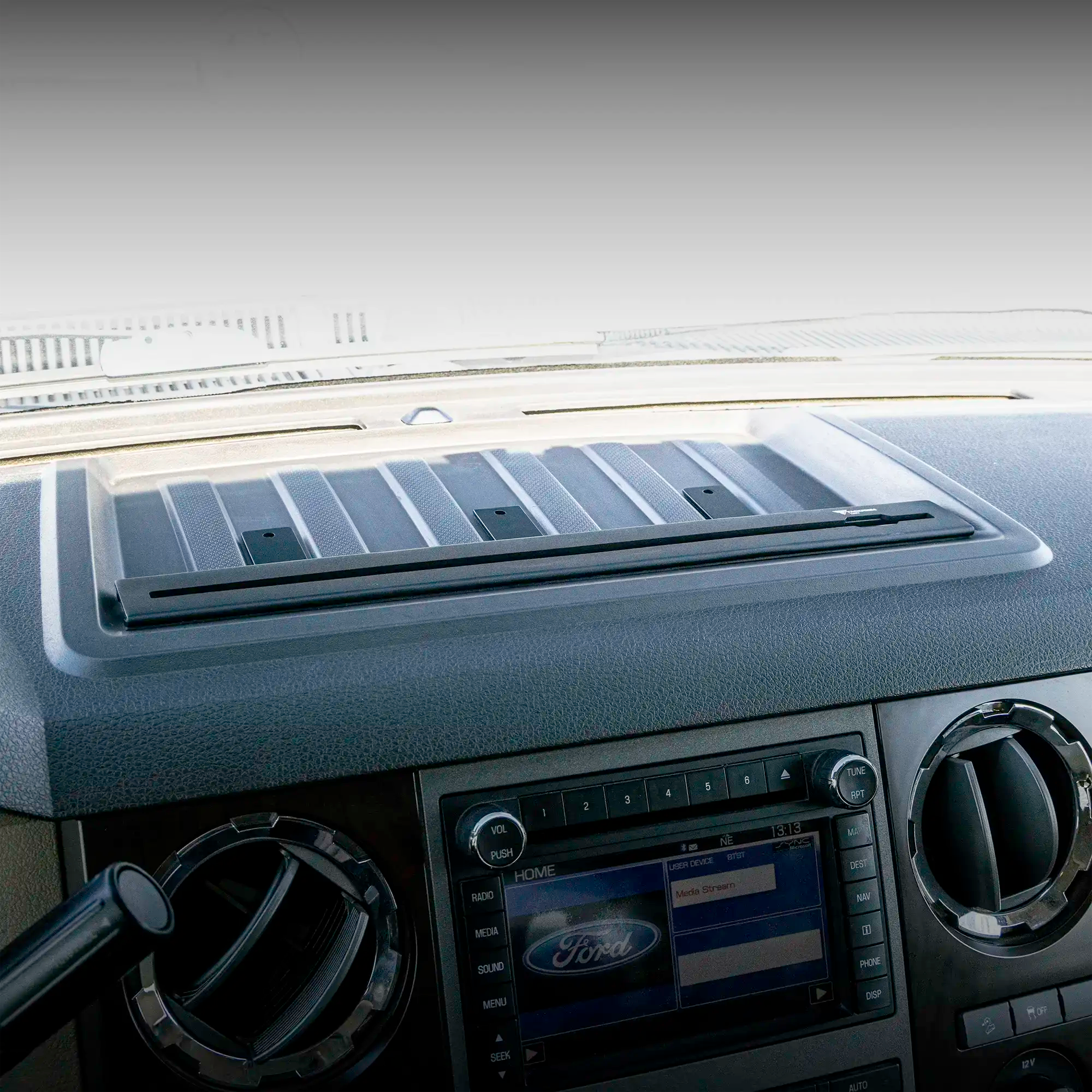 Driver side perspective of dash bracket mount installed in a Ford Super Duty