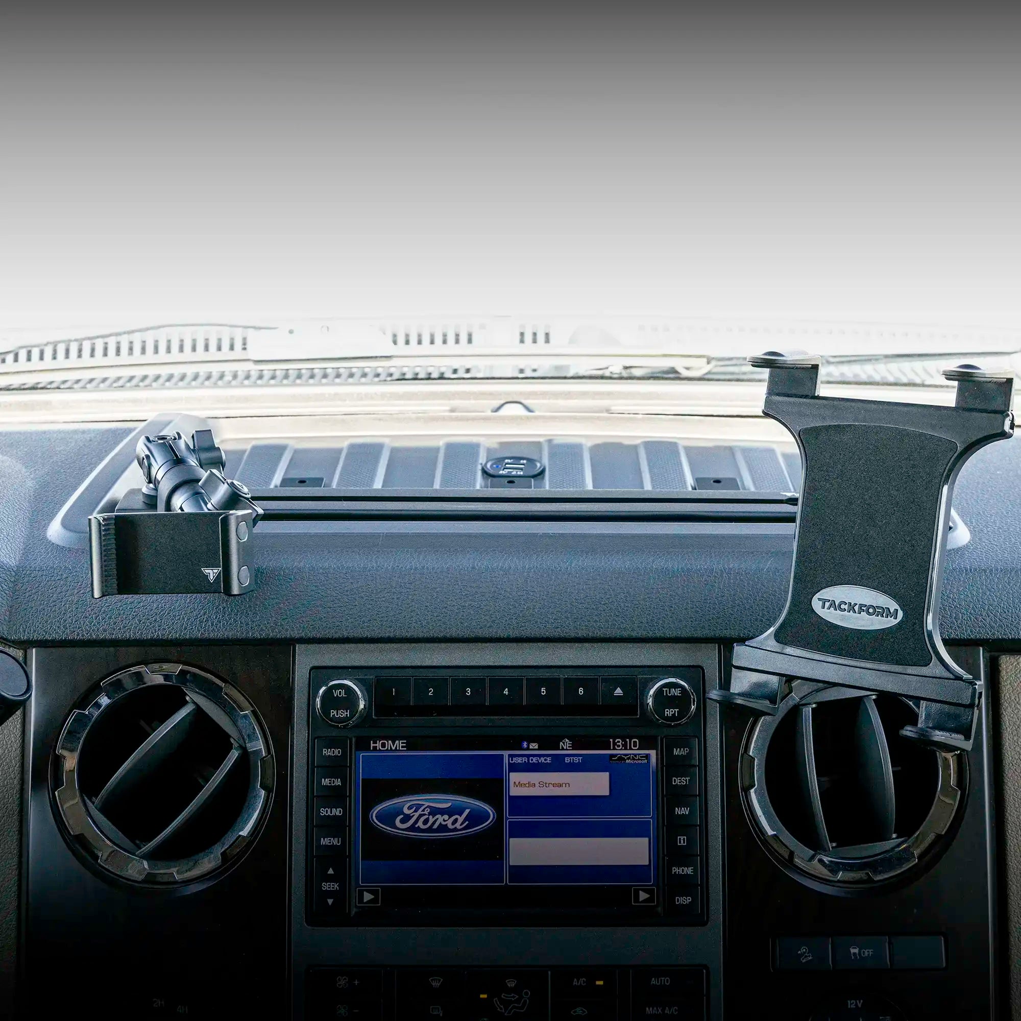 Dash bracket installed in a Ford Super Duty with phone mount and tablet mount