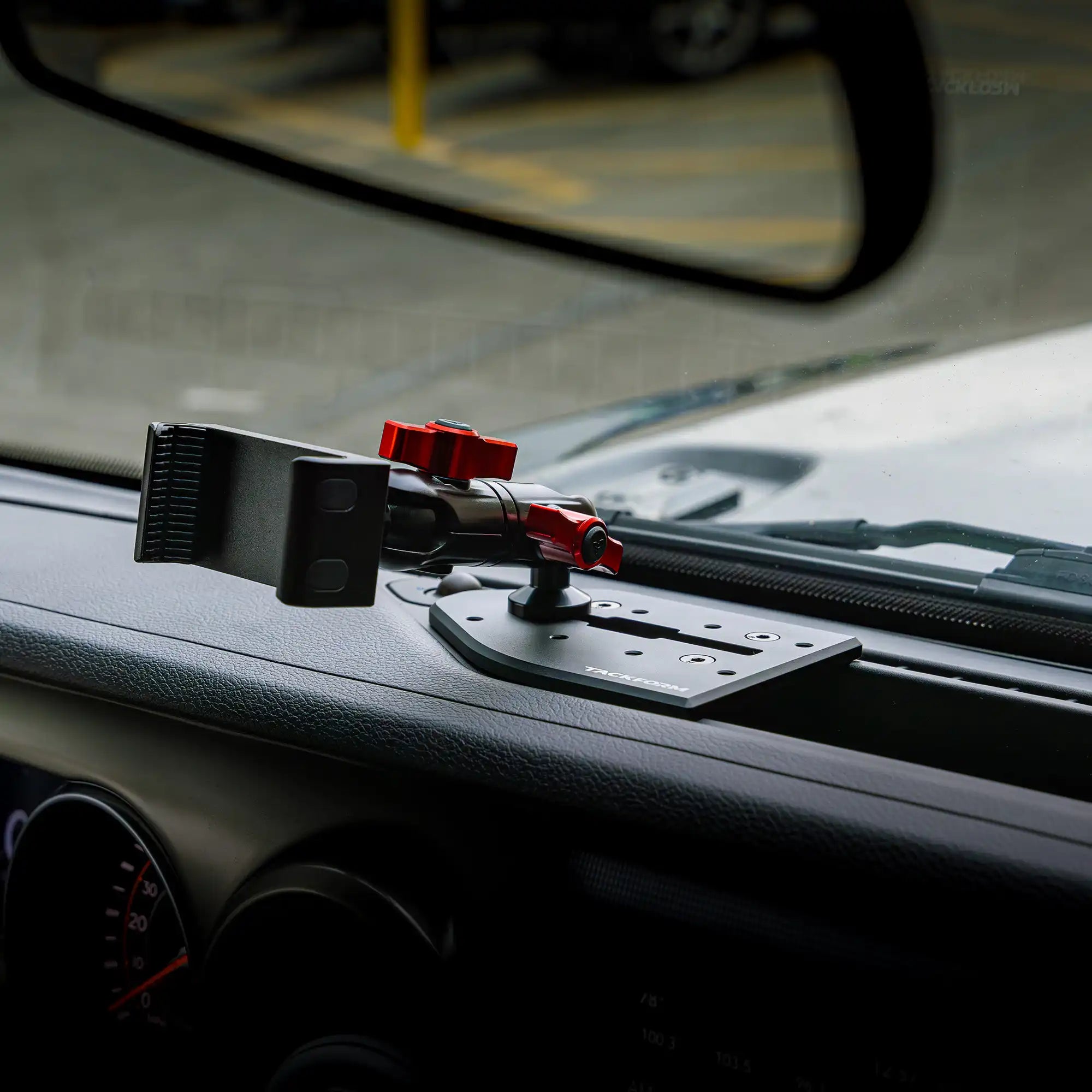 Tackform Jeep Wrangler Dash Kit with Spring Phone Cradle Installed on a Jeep Wrangler with Red Color Accent Knobs